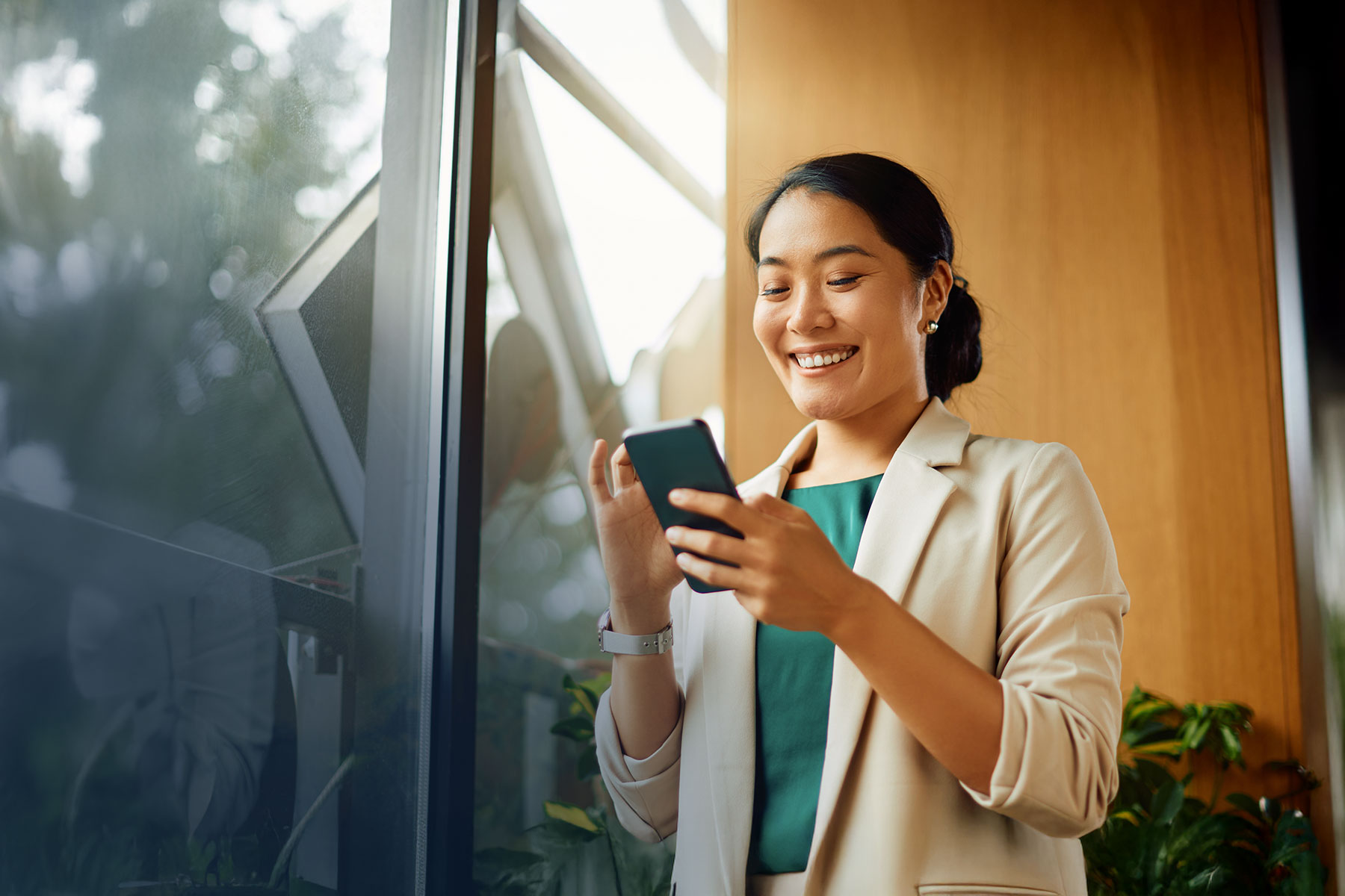 ErlangerNOW banner - woman using app on phone