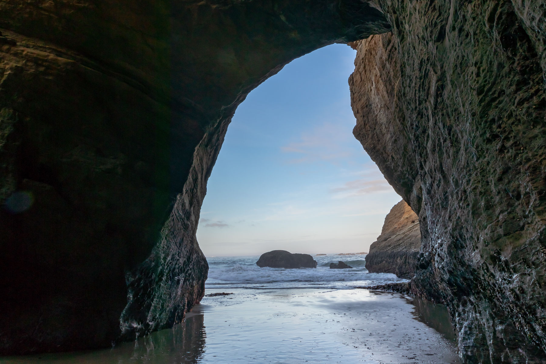 Paths & Portals banner image - looking out to ocean from rock bridge